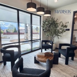 lounge with seating tables and large windows