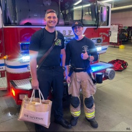 firefighters holding a package from The Madison at Stetson Hills