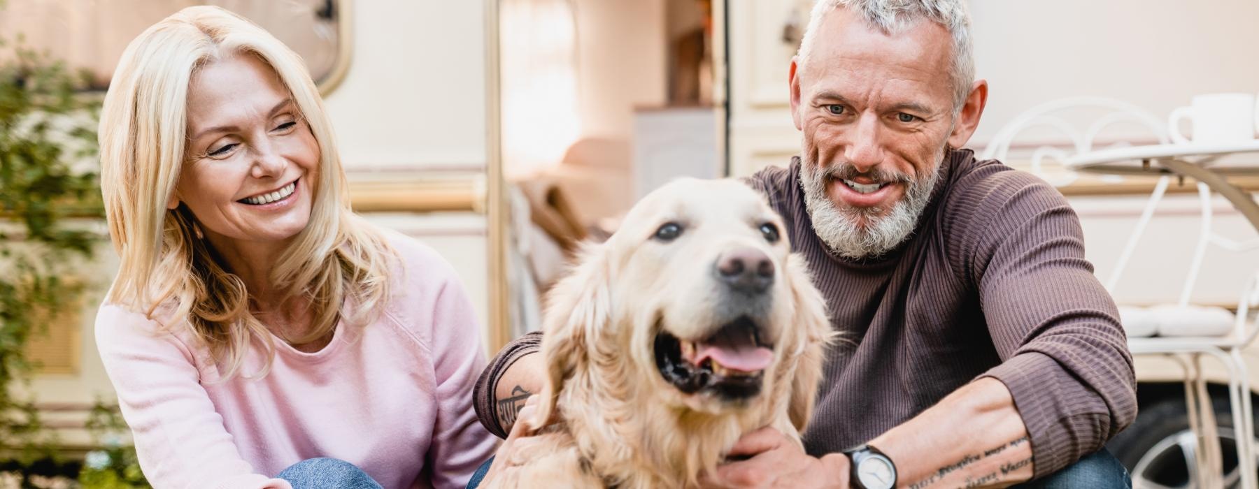 a man and a woman holding a dog