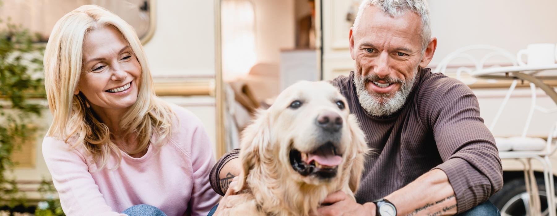 a man and a woman holding a dog