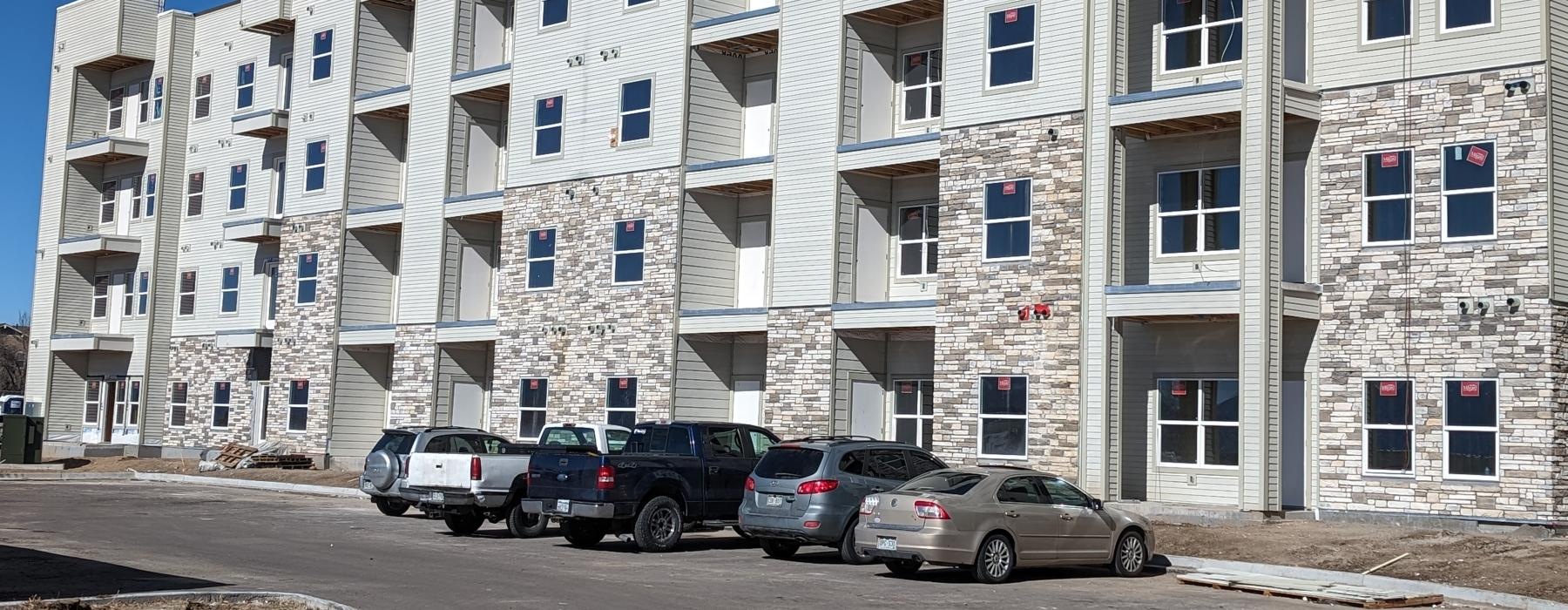 a building with cars parked in front